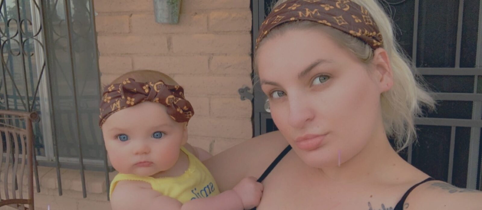 An adult is taking a selfie with a baby both with a light skin tone, using a digital filter.