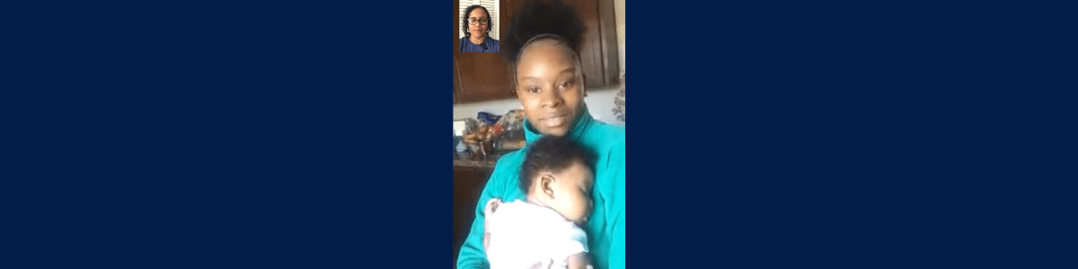 A screenshot of a FaceTime call between two adults, with one holding a sleeping baby in their arms, all with a dark skin tone.